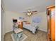 Light-filled bedroom with hard surface floors and ceiling fan and window shutters at 727 Flamingo Dr, Apollo Beach, FL 33572