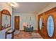 Welcoming entryway with hardwood floors, double doors, and a cozy bench, creating a warm first impression at 727 Flamingo Dr, Apollo Beach, FL 33572