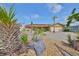 Landscaped front yard of a single-story home with a circular driveway and attached garage at 727 Flamingo Dr, Apollo Beach, FL 33572