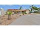 Single-story home featuring a circular driveway, palm trees, an attached garage, and well-maintained landscaping at 727 Flamingo Dr, Apollo Beach, FL 33572