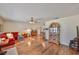 Bright living room featuring hardwood floors, neutral walls, and a comfortable red sofa at 727 Flamingo Dr, Apollo Beach, FL 33572