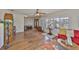 Open living room featuring hardwood floors, lots of natural light, and access to the entry at 727 Flamingo Dr, Apollo Beach, FL 33572