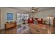 Cozy living room featuring hardwood floors, a bright window, and a comfortable red sofa at 727 Flamingo Dr, Apollo Beach, FL 33572