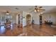 Spacious living room with hardwood floors, ceiling fan, and access to the dining area at 727 Flamingo Dr, Apollo Beach, FL 33572