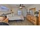 Cozy bedroom features wood-look flooring, a ceiling fan, and plantation shutters for natural light at 727 Flamingo Dr, Apollo Beach, FL 33572