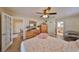 Spacious bedroom with wood-look flooring, ceiling fan, and access to an en suite bathroom at 727 Flamingo Dr, Apollo Beach, FL 33572