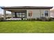 Lush backyard featuring a covered patio and sliding glass doors at 8521 Dove Bog Ter, Parrish, FL 34219