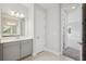 Bathroom showcasing a gray vanity with white countertops and a walk through to the bedroom at 8521 Dove Bog Ter, Parrish, FL 34219