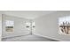 Bright bedroom featuring neutral walls and carpet, with natural light from three large windows at 8521 Dove Bog Ter, Parrish, FL 34219
