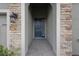 Inviting front entry with a stylish door, stone accents, and a covered porch at 8521 Dove Bog Ter, Parrish, FL 34219