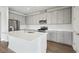 Beautiful kitchen with stainless appliances, gray cabinets, and a spacious center island at 8521 Dove Bog Ter, Parrish, FL 34219