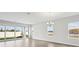 Sunlit living room featuring sliding glass doors and luxury vinyl flooring at 8521 Dove Bog Ter, Parrish, FL 34219