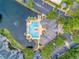 An aerial view of the community pool and surrounding landscaping with a water view at 8742 Mallard Reserve Dr # 101, Tampa, FL 33614