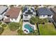 Aerial view of home showing backyard pool, patio, and solar panels at 8890 Arabella Ln, Seminole, FL 33777