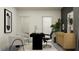 Well-lit office space with a desk, chairs, a storage cabinet, and stylish decor at 9493 Runaway Breeze Dr, Land O Lakes, FL 34637