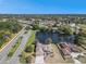 An aerial view of a neighborhood with mature trees surrounding a lake near the single Gathering home at 10084 Twelve Oaks Ct, Weeki Wachee, FL 34613