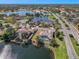 Scenic aerial view of a lakeside community showcasing homes with private pools and lush landscaping at 10084 Twelve Oaks Ct, Weeki Wachee, FL 34613