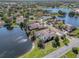 Stunning aerial view of homes nestled among lakes, featuring mature trees and well-kept lawns at 10084 Twelve Oaks Ct, Weeki Wachee, FL 34613
