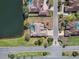 Aerial shot of the property featuring a backyard pool, mature trees, and a well-manicured lawn at 10084 Twelve Oaks Ct, Weeki Wachee, FL 34613