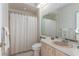 Bathroom with patterned wallpaper, bathtub with shower, and vanity at 10084 Twelve Oaks Ct, Weeki Wachee, FL 34613