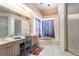 Spacious bathroom features a double sink vanity, soaking tub with curtains, and a glass door shower at 10084 Twelve Oaks Ct, Weeki Wachee, FL 34613