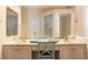 Bright bathroom with double vanity, a large mirror, and a glass-enclosed shower at 10084 Twelve Oaks Ct, Weeki Wachee, FL 34613