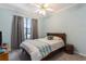 Bright bedroom featuring a ceiling fan, neutral walls, and a large window at 10084 Twelve Oaks Ct, Weeki Wachee, FL 34613