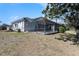 Exterior of the home showcasing a screened-in pool area and a spacious backyard, ideal for outdoor living at 10084 Twelve Oaks Ct, Weeki Wachee, FL 34613
