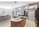 Open-concept kitchen and living area with center island and stainless steel appliances at 10084 Twelve Oaks Ct, Weeki Wachee, FL 34613
