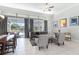 Living room with tile flooring, contemporary furniture, large windows, and sliding glass doors to the lanai at 10084 Twelve Oaks Ct, Weeki Wachee, FL 34613