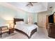 Bright bedroom with a tray ceiling, carpeting, and ensuite bathroom at 10084 Twelve Oaks Ct, Weeki Wachee, FL 34613