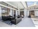Spacious patio with wicker furniture, dining table and glass doors at 10084 Twelve Oaks Ct, Weeki Wachee, FL 34613