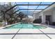 Inviting screened-in pool with spa and ample deck space, perfect for outdoor relaxation and entertaining at 10084 Twelve Oaks Ct, Weeki Wachee, FL 34613