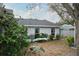 Backyard featuring plants and the home's rear facade at 1016 Greenleaf Way, Tarpon Springs, FL 34689