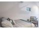 Bright bedroom featuring a cozy bed with a soft throw blanket and accent chair at 1016 Greenleaf Way, Tarpon Springs, FL 34689