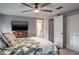 Well-lit bedroom with an en-suite bathroom and closet featuring a ceiling fan and white trim at 1016 Greenleaf Way, Tarpon Springs, FL 34689