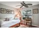 Cozy bedroom with natural light, daybed, decorative wall art, and ceiling fan at 1016 Greenleaf Way, Tarpon Springs, FL 34689