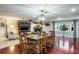 Open dining room with wood floors, fireplace, and modern light fixture at 1016 Greenleaf Way, Tarpon Springs, FL 34689
