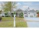 Charming single-story home featuring lush tropical landscaping and a welcoming front porch at 1016 Greenleaf Way, Tarpon Springs, FL 34689