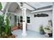 Inviting front porch features a decorative fish art piece and comfortable seating area at 1016 Greenleaf Way, Tarpon Springs, FL 34689