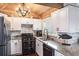 Well-lit kitchen with granite counters, stainless steel appliances, and cedar ceiling at 1016 Greenleaf Way, Tarpon Springs, FL 34689