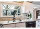 Kitchen sink with granite counters, and large window to the exterior at 1016 Greenleaf Way, Tarpon Springs, FL 34689