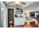 Open kitchen with wooden floors, granite counters, coffee station and laundry room access at 1016 Greenleaf Way, Tarpon Springs, FL 34689