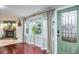 Bright living room features hardwood floors and a decorative fireplace at 1016 Greenleaf Way, Tarpon Springs, FL 34689