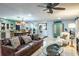 Open-concept living room with hardwood flooring, stylish furniture, and barn door at 1016 Greenleaf Way, Tarpon Springs, FL 34689