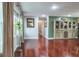 Bright living room featuring hardwood flooring and a view of the hallway at 1016 Greenleaf Way, Tarpon Springs, FL 34689