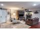 Cozy living room with a stone fireplace, ceiling fan, and built in shelving for a TV unit at 1016 Greenleaf Way, Tarpon Springs, FL 34689