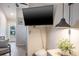 Open living space with a large TV, stylish lighting, and a view of the exterior at 1016 Greenleaf Way, Tarpon Springs, FL 34689