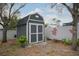 Backyard shed with a gray paint, set on a bed of gravel at 1016 Greenleaf Way, Tarpon Springs, FL 34689