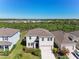 Charming two-story home with a well-kept lawn, complemented by lush landscaping for great curb appeal at 10741 Charlotte Dr, Parrish, FL 34219